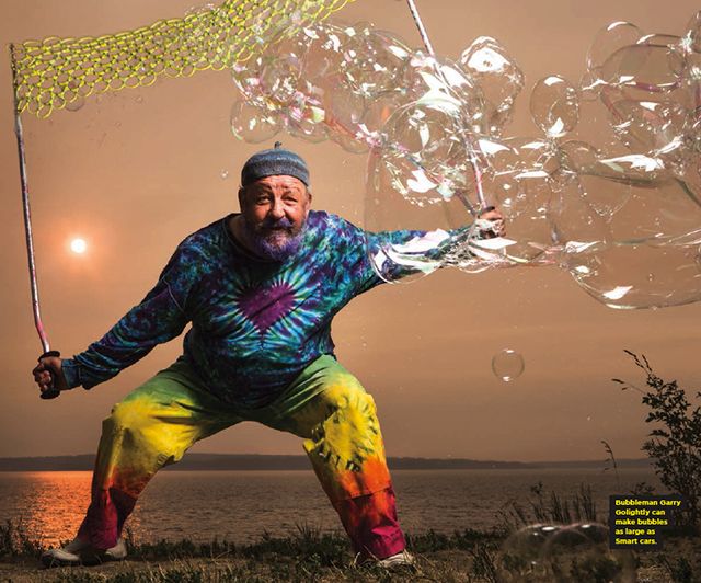 The Bubbleman in tie-dye, swinging a giant bubble net at sunset