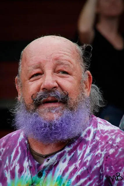 Garry smiling, purple beard and tie-dye