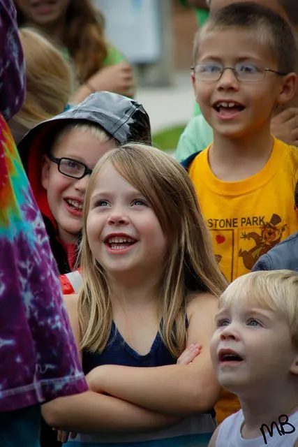 Children laughing up at the bubbles