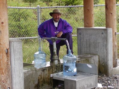 Jugs being filled at the free artesian well